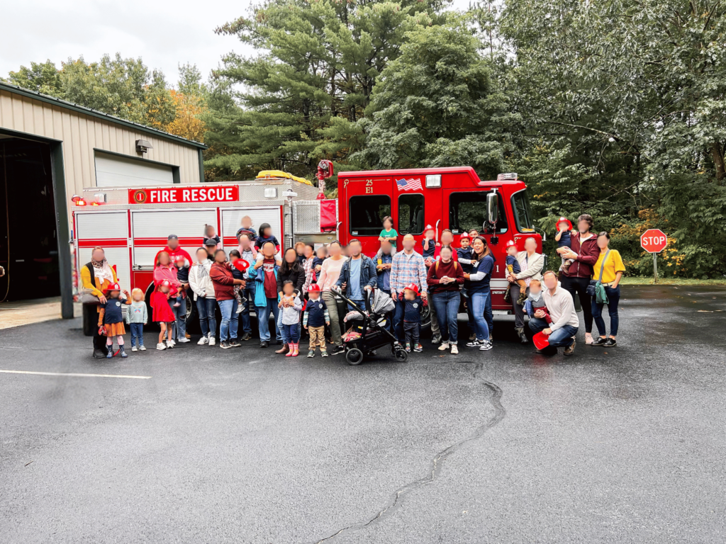 Group shot in front of Fire Truck.  Faces blurred for all except family